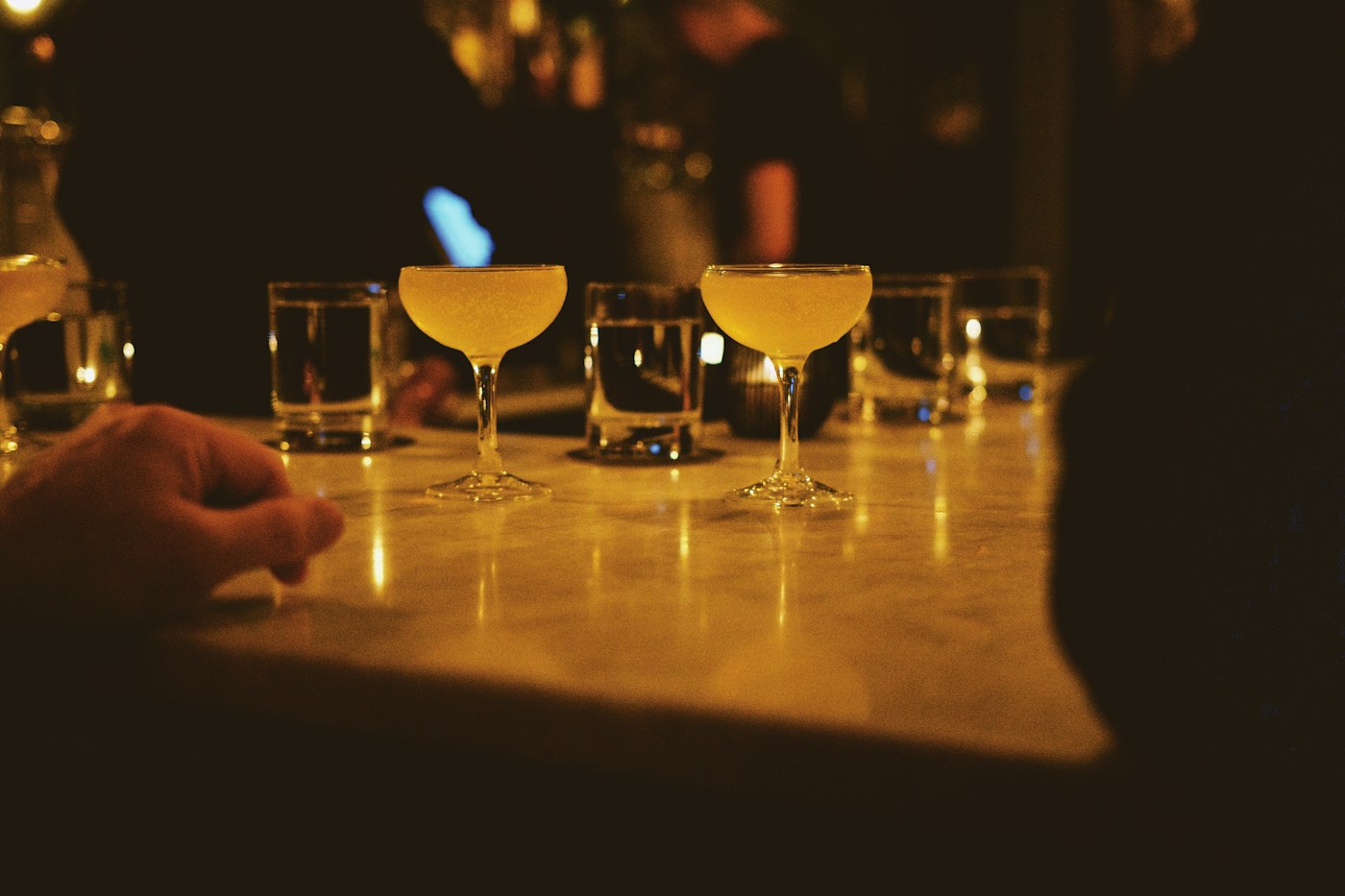 Adults talking together at a bar