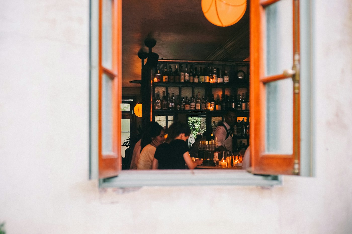 People talking inside a warmly lit wine bar